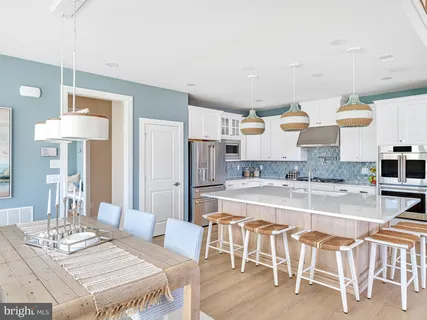 a large kitchen with a table and chairs in it