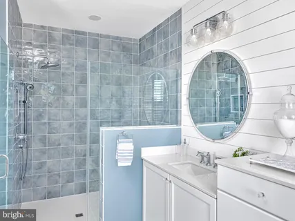 a bathroom with a sink mirror and bathtub