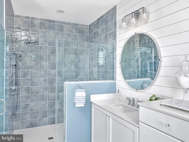 a bathroom with a sink mirror and bathtub
