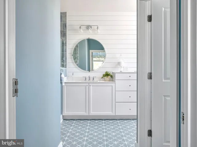a bathroom with a sink a vanity and a mirror