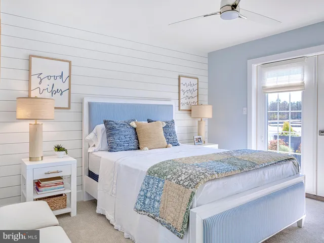 a bedroom with a bed and a dresser next to a window