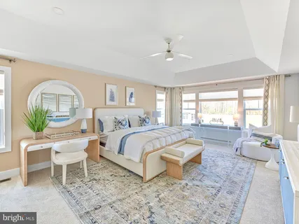 a living room with a bed furniture and a large window