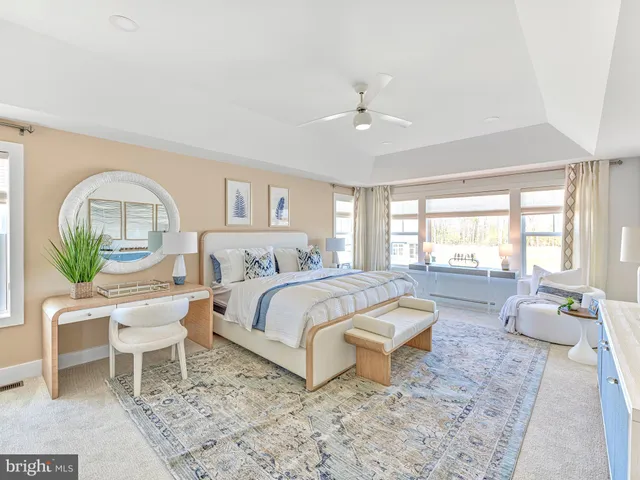 a living room with a bed furniture and a large window