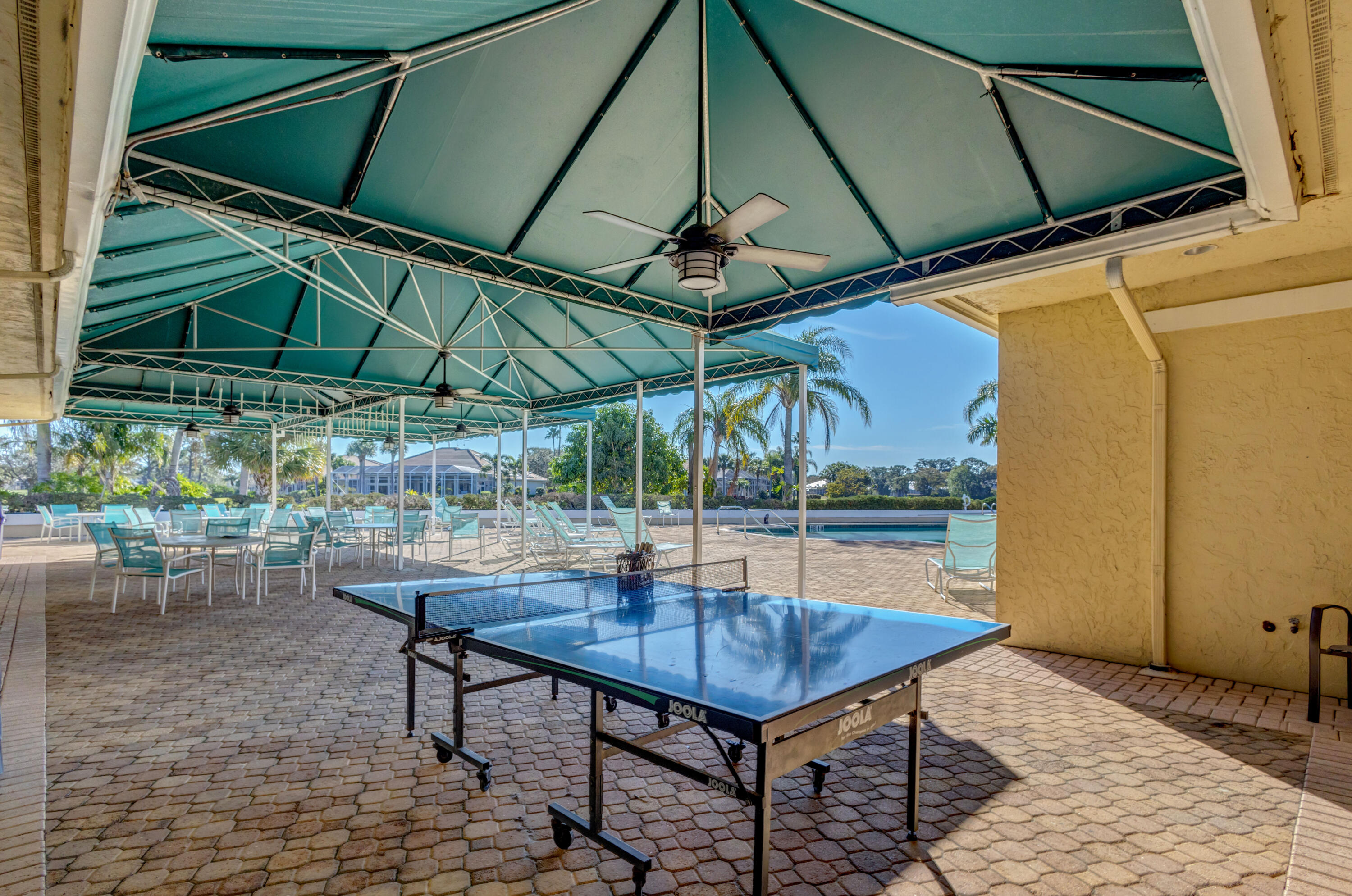 2199 Southwest Brookhaven Way Palm City, FL 34990 - Photo 107 of 119 a view of a backyard with table and chairs under an umbrella