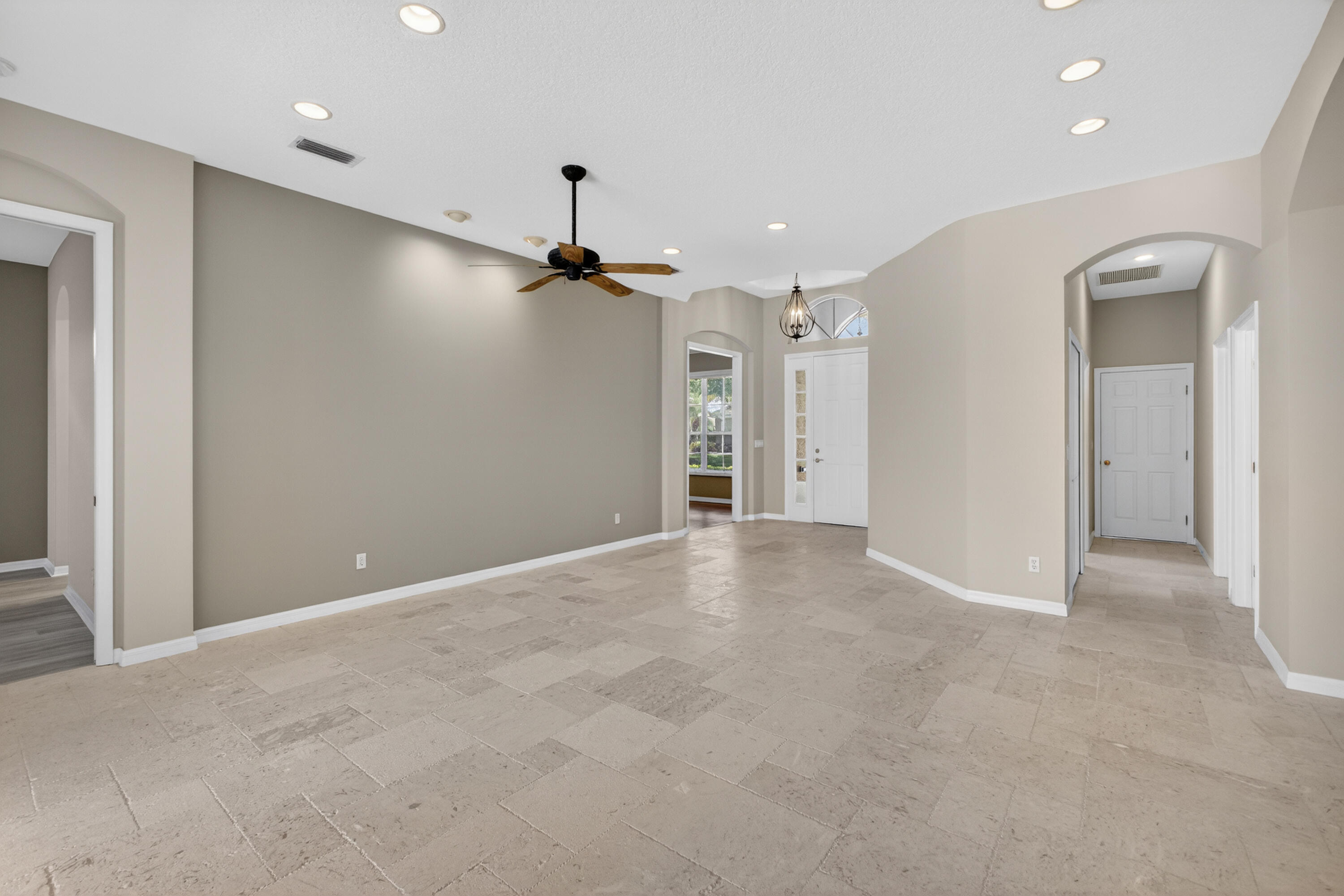 2199 Southwest Brookhaven Way Palm City, FL 34990 - Photo 16 of 119 a view of a hallway with a ceiling fan