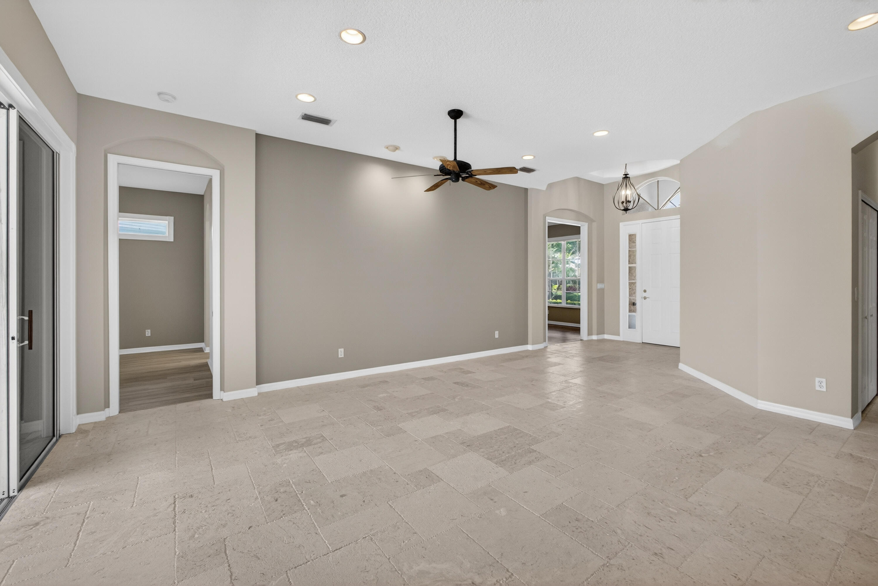 2199 Southwest Brookhaven Way Palm City, FL 34990 - Photo 17 of 119 a view of a hallway with a ceiling fan