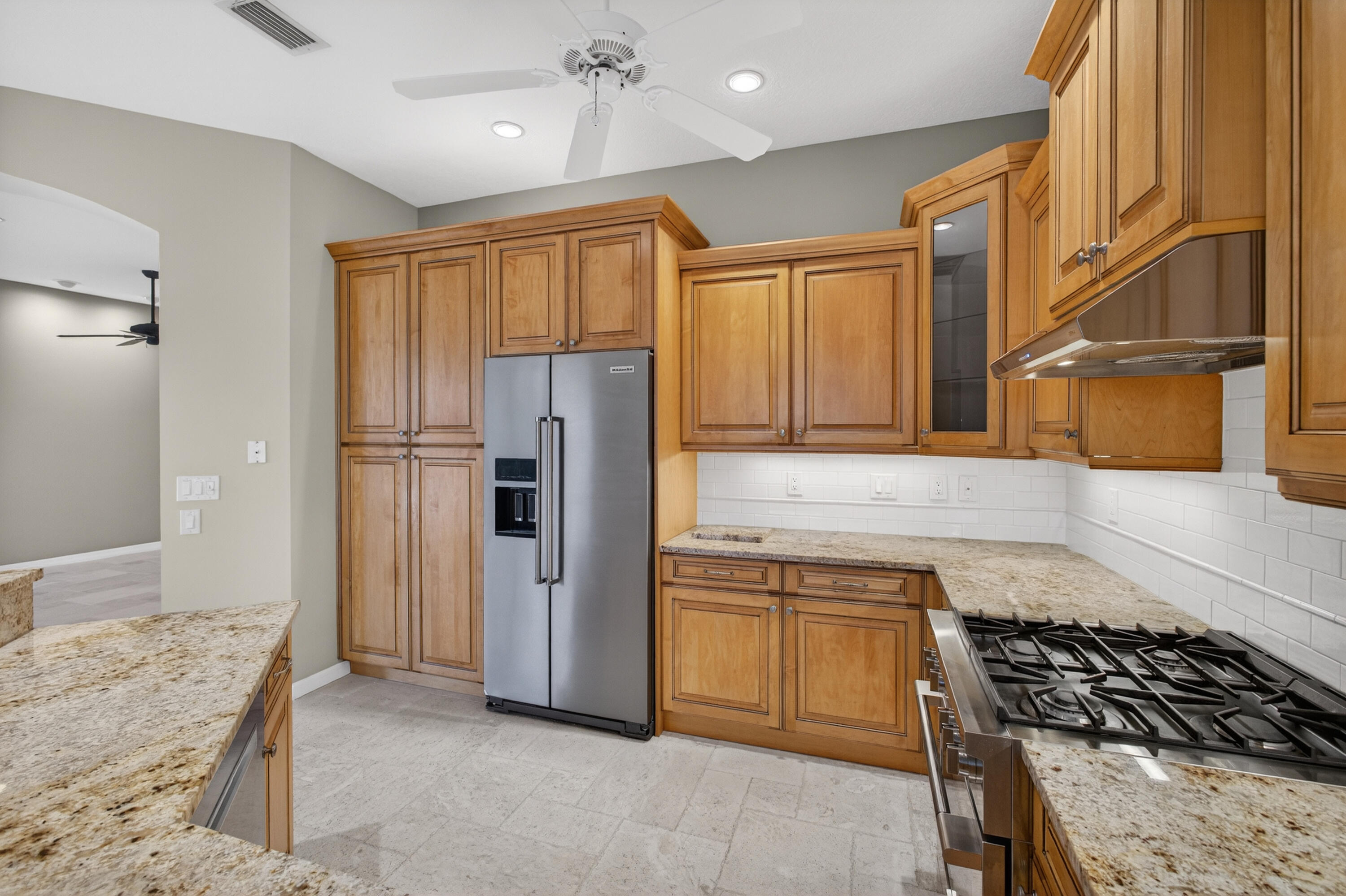 2199 Southwest Brookhaven Way Palm City, FL 34990 - Photo 24 of 119 a kitchen with stainless steel appliances granite countertop a refrigerator and a sink