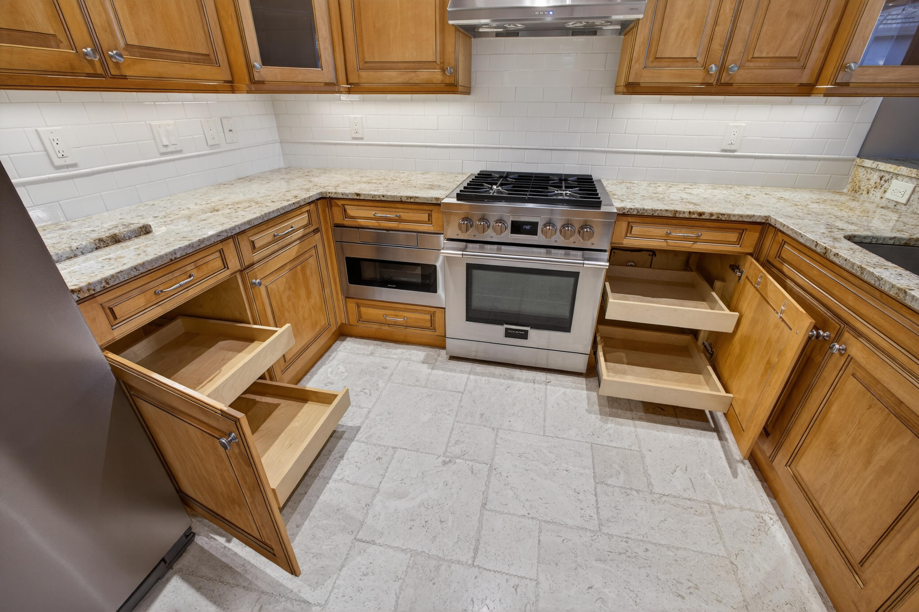 2199 Southwest Brookhaven Way Palm City, FL 34990 - Photo 30 of 119 a kitchen with granite countertop a stove top oven and cabinets