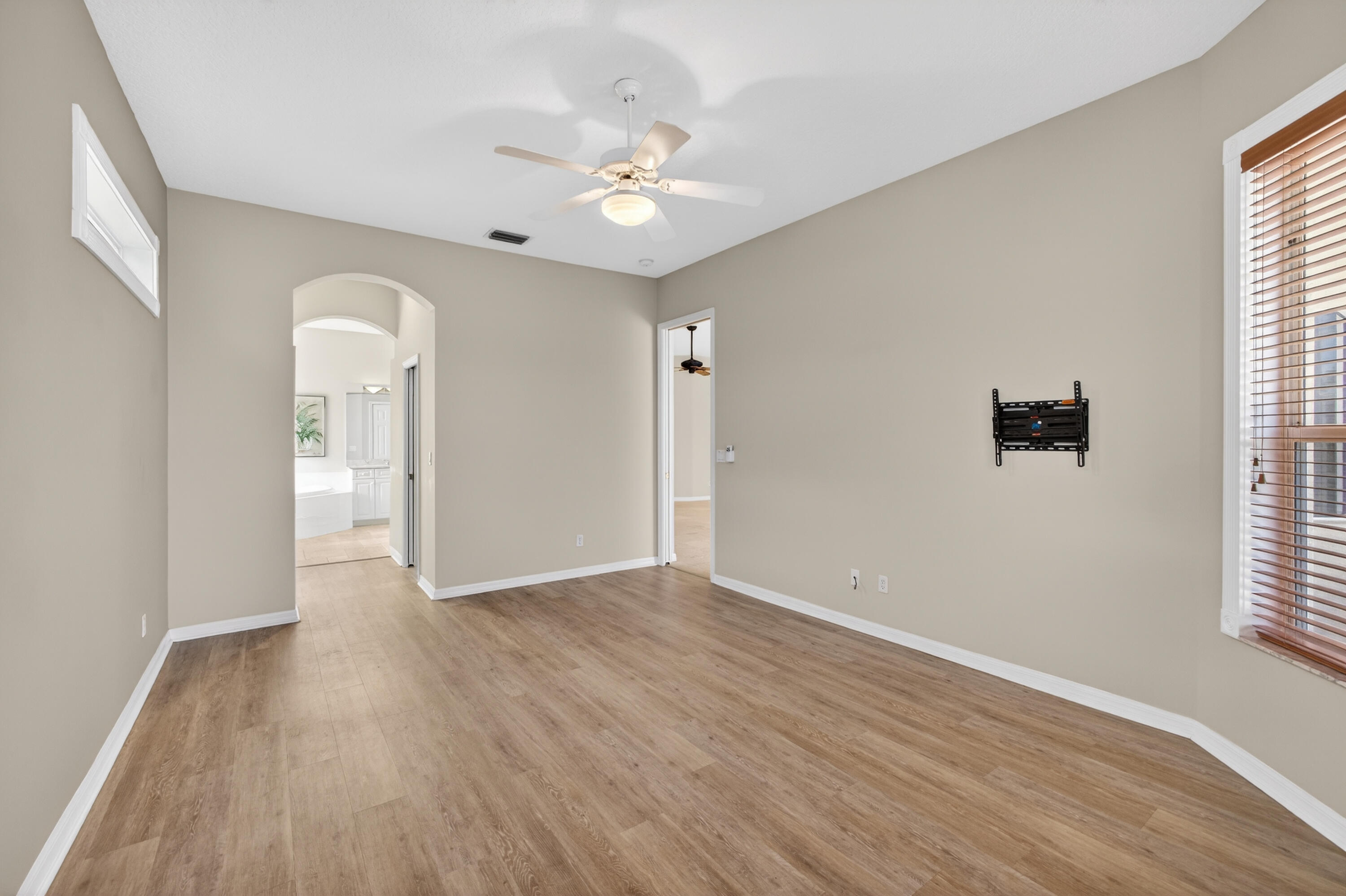 2199 Southwest Brookhaven Way Palm City, FL 34990 - Photo 41 of 119 a view of an empty room with a window and wooden floor