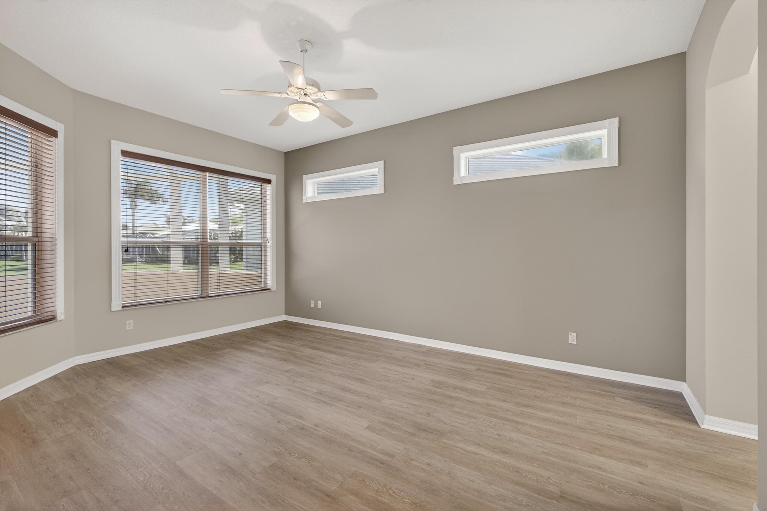 2199 Southwest Brookhaven Way Palm City, FL 34990 - Photo 43 of 119 a view of an empty room with a window and wooden floor