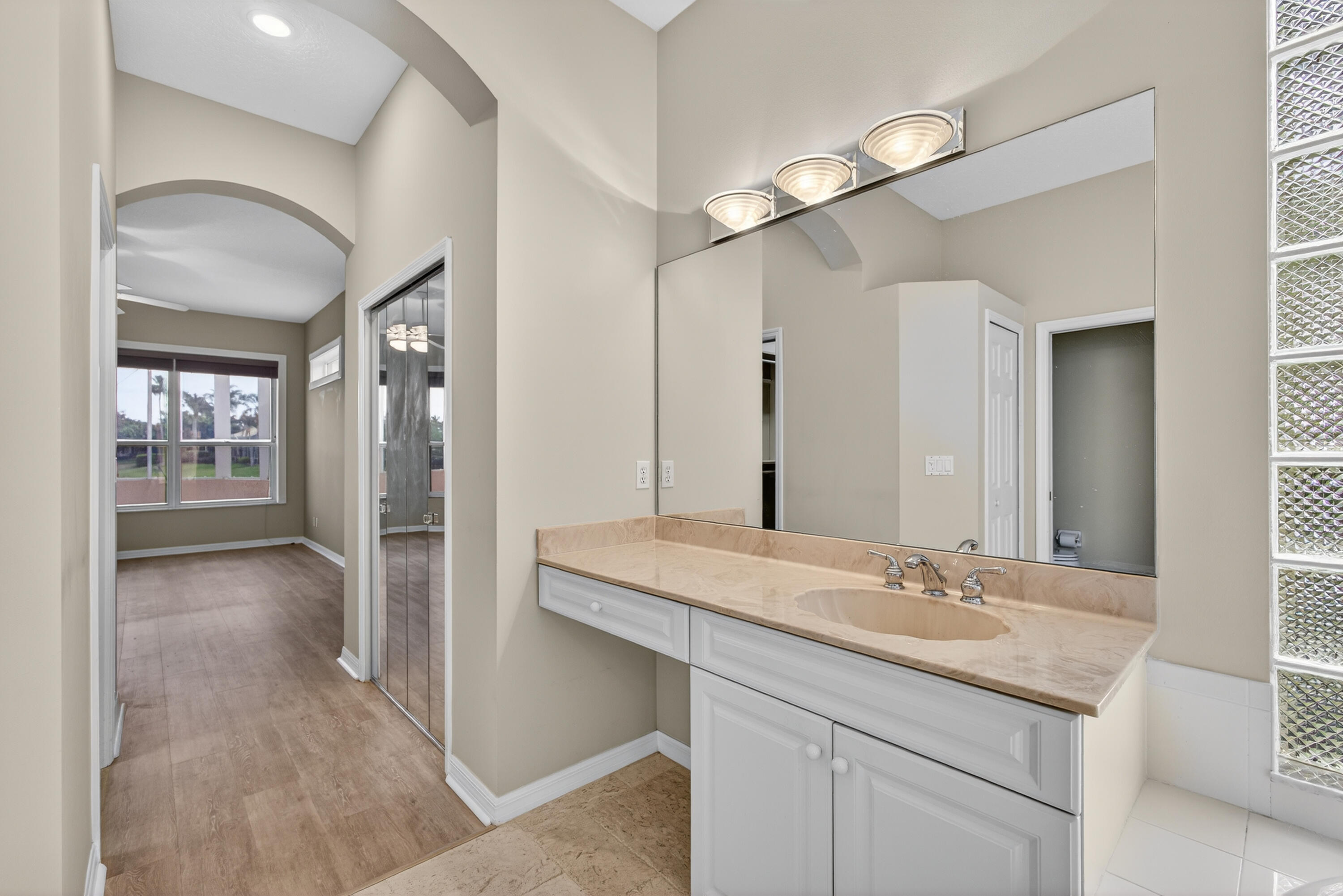 2199 Southwest Brookhaven Way Palm City, FL 34990 - Photo 51 of 119 a bathroom with a sink and a mirror