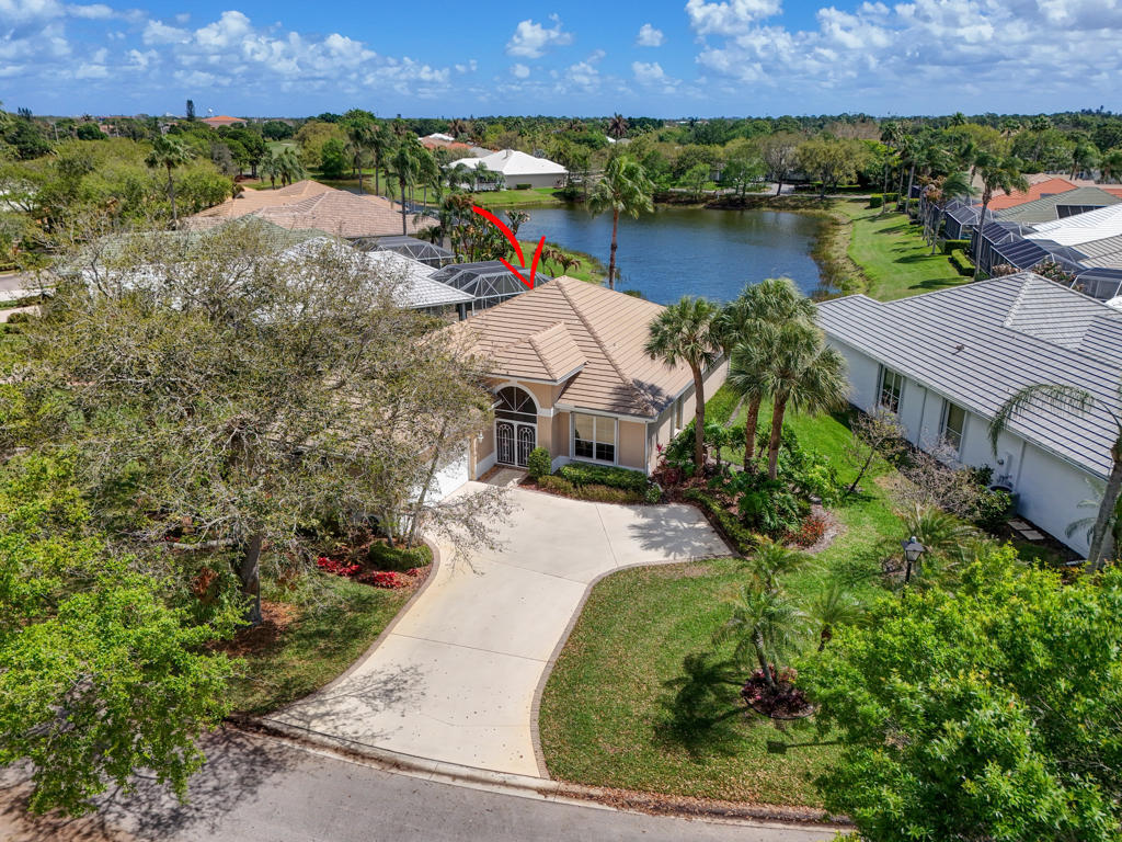 2199 Southwest Brookhaven Way Palm City, FL 34990 - Photo 78 of 119 an aerial view of a house with a garden and lake view