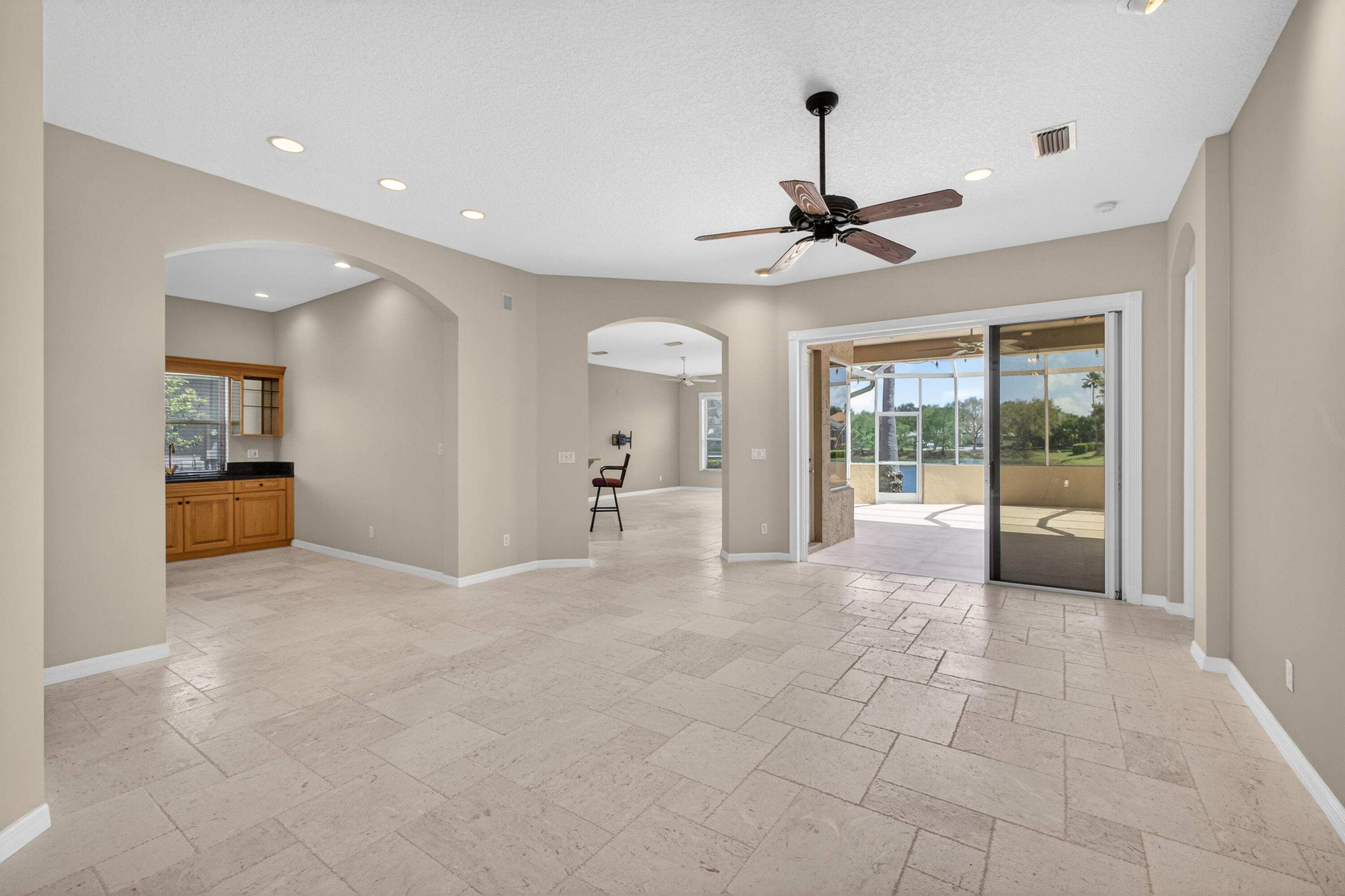 2199 Southwest Brookhaven Way Palm City, FL 34990 - Photo 10 of 119 a view of a livingroom with a chandelier fan and windows