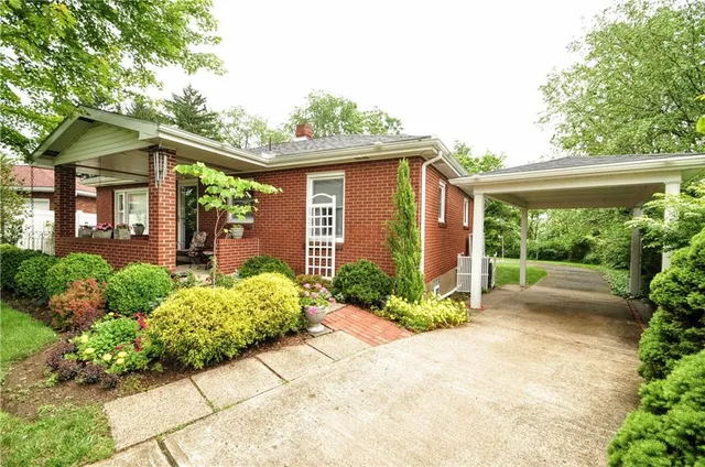 a front view of a house with garden