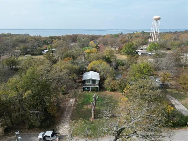 an aerial view of a house with a yard