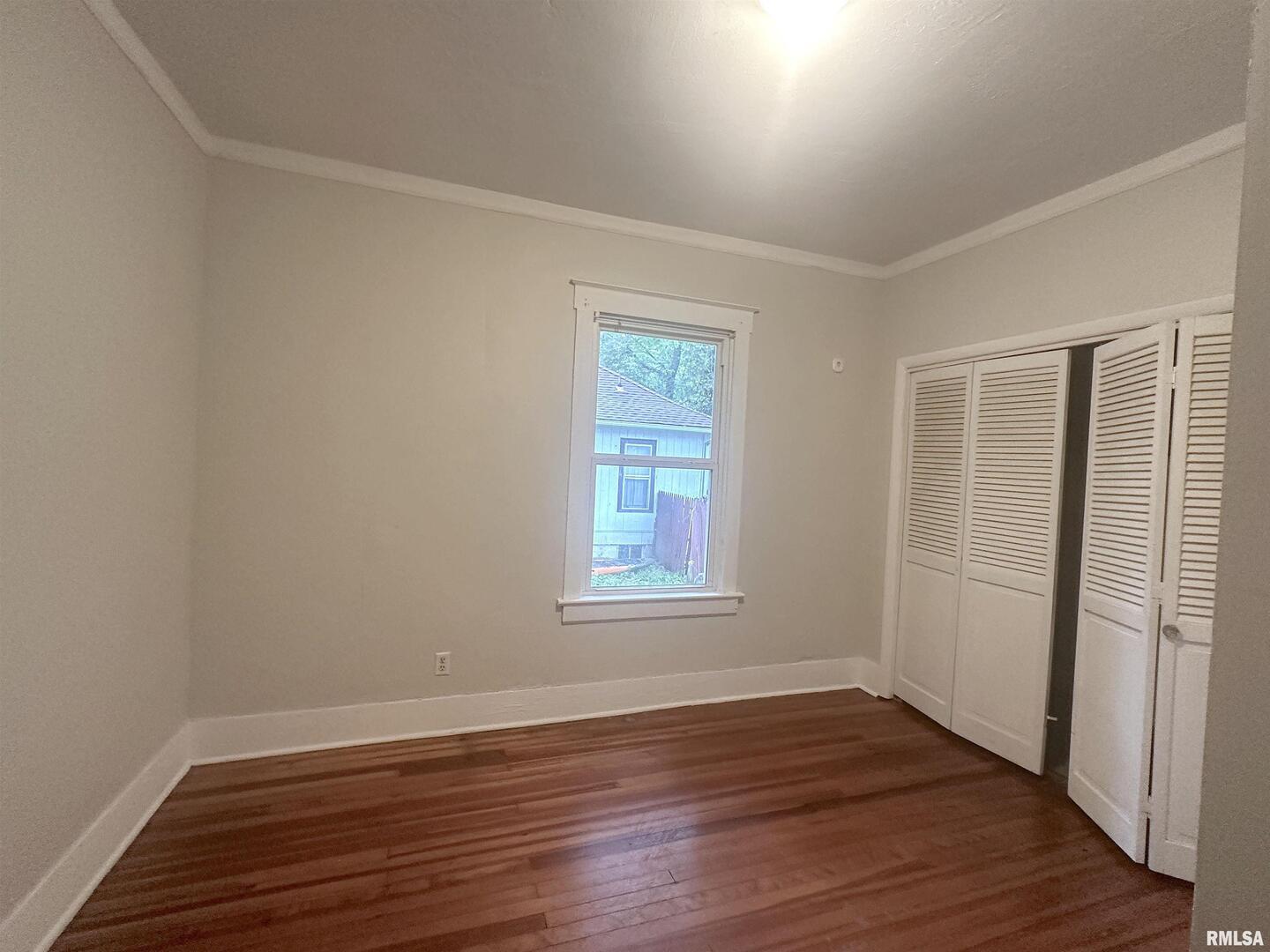 604 West Walnut Street Carbondale, IL 62901 - Photo 11 of 18 a view of an empty room with wooden floor and a window