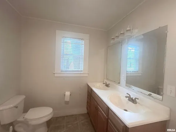 a bathroom with a sink toilet and mirror