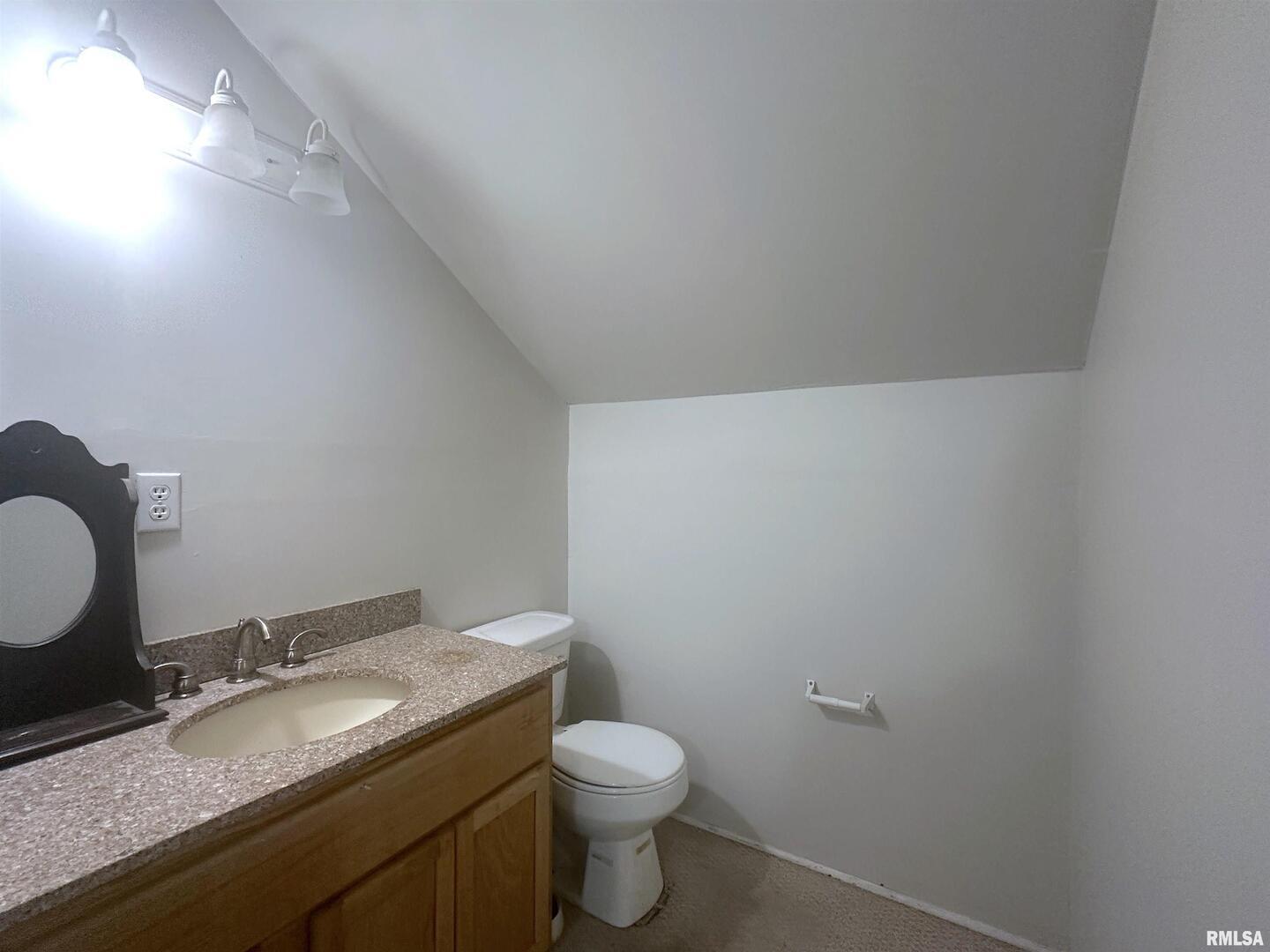 604 West Walnut Street Carbondale, IL 62901 - Photo 17 of 18 a bathroom with a granite countertop toilet and a sink