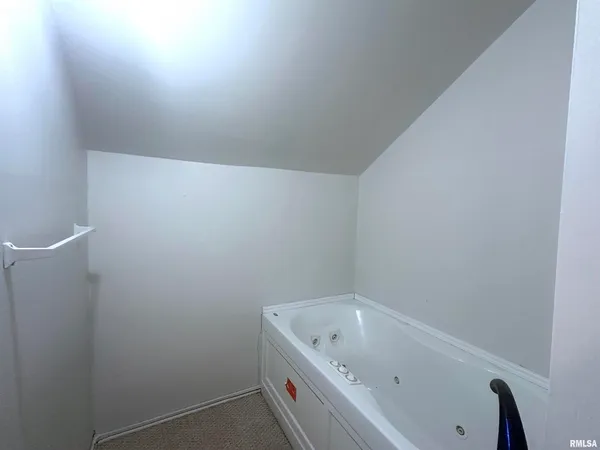 a bathroom with a tub and sink