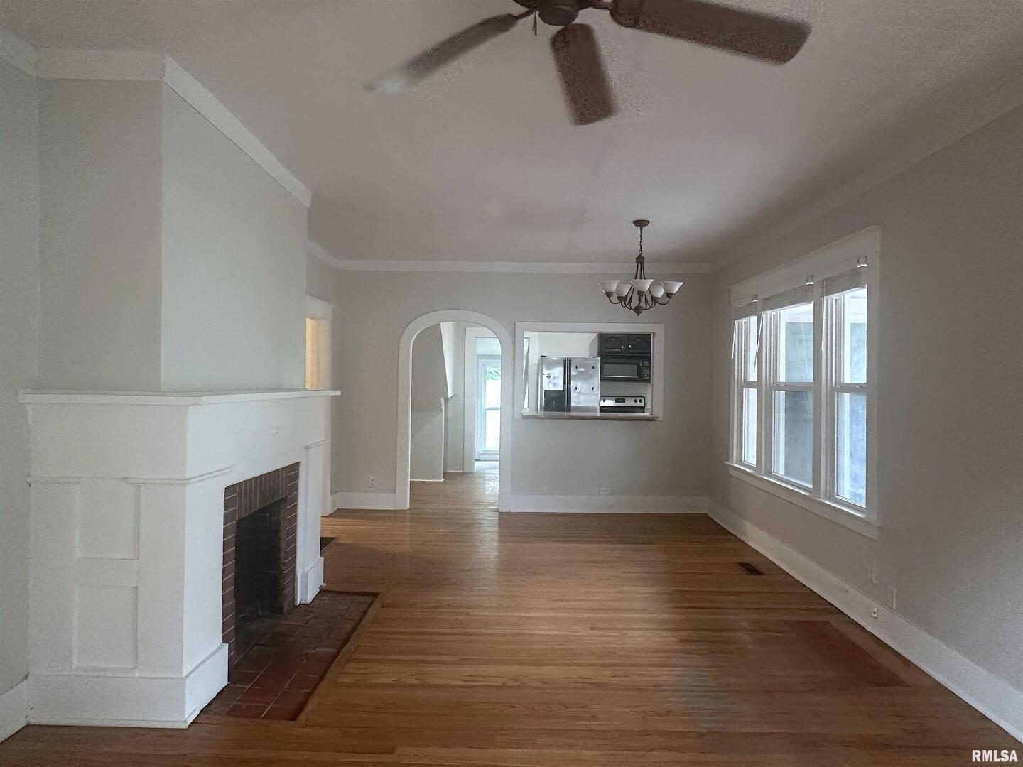 604 West Walnut Street Carbondale, IL 62901 - Photo 5 of 18 a view of empty room with wooden floor and fireplace