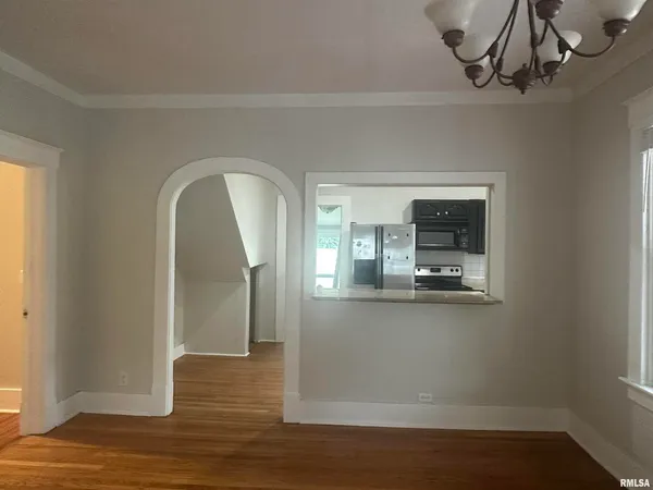 a view of a room with wooden floor and staircase