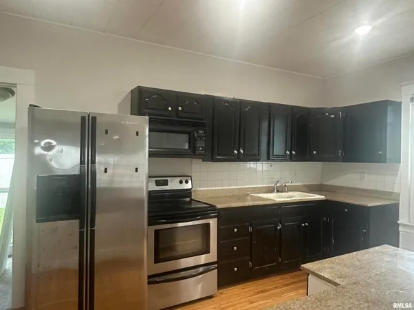 a kitchen with a sink and a refrigerator