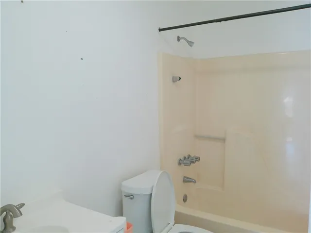 a bathroom with a shower and a toilet