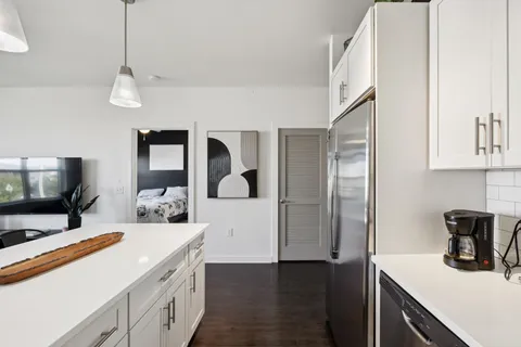 a kitchen with stainless steel appliances a stove microwave and sink