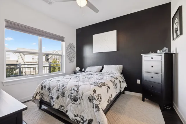 a bedroom with a bed and a large window