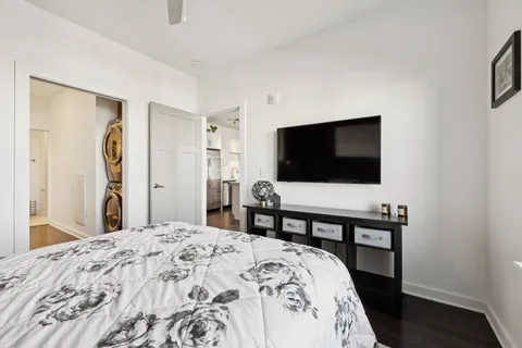 a bedroom with a bed and a flat screen tv