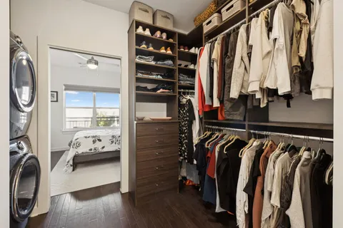 a view of walk in closet with clothes and shoes