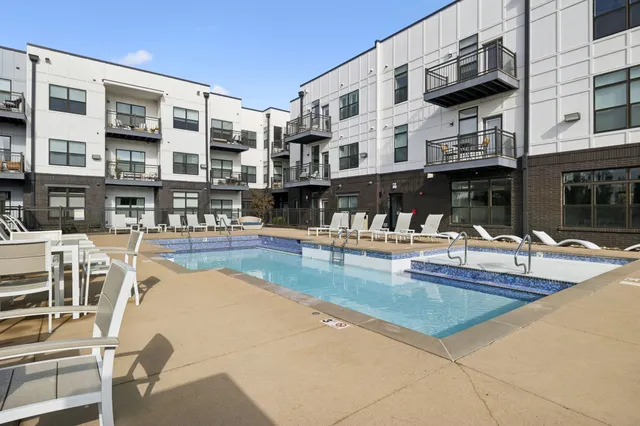 a view of a swimming pool with outdoor seating