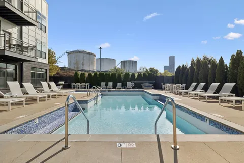 a view of a swimming pool with outdoor seating