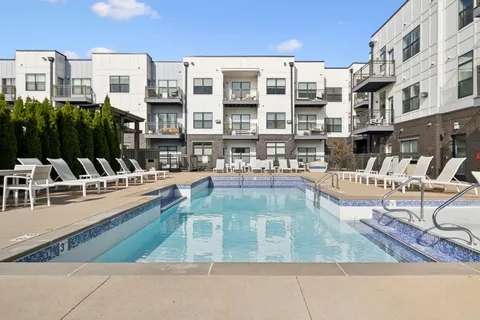 a view of a swimming pool with outdoor seating