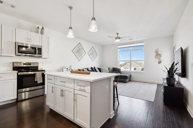 a kitchen with a sink stove and microwave
