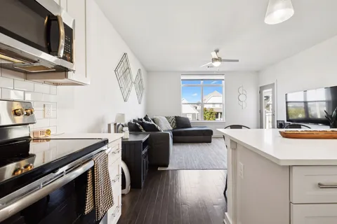 a open kitchen with sink stove and cabinets