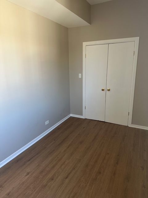 2956 North Hamlin Avenue, Unit 2R Chicago, IL 60618 - Photo 3 of 9 a view of an empty room with wooden floor