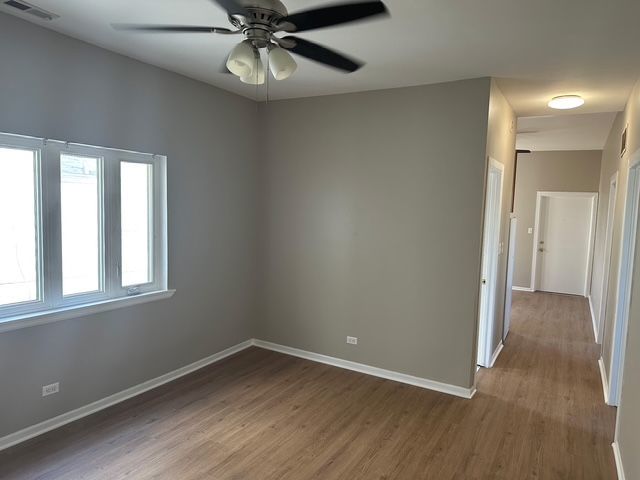 2956 North Hamlin Avenue, Unit 2R Chicago, IL 60618 - Photo 7 of 9 wooden floor in an empty room with a window