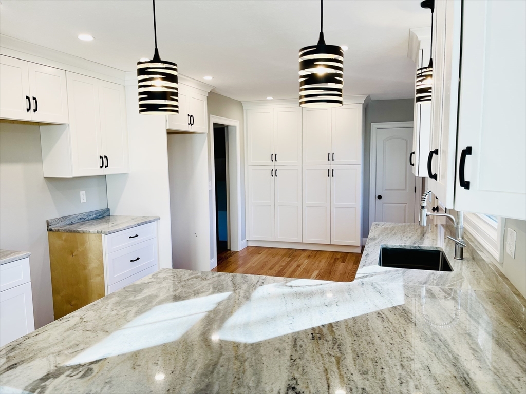 144 Viscount Road Longmeadow, MA 01106 - Photo 8 of 38 a bedroom with a bed and a chandelier