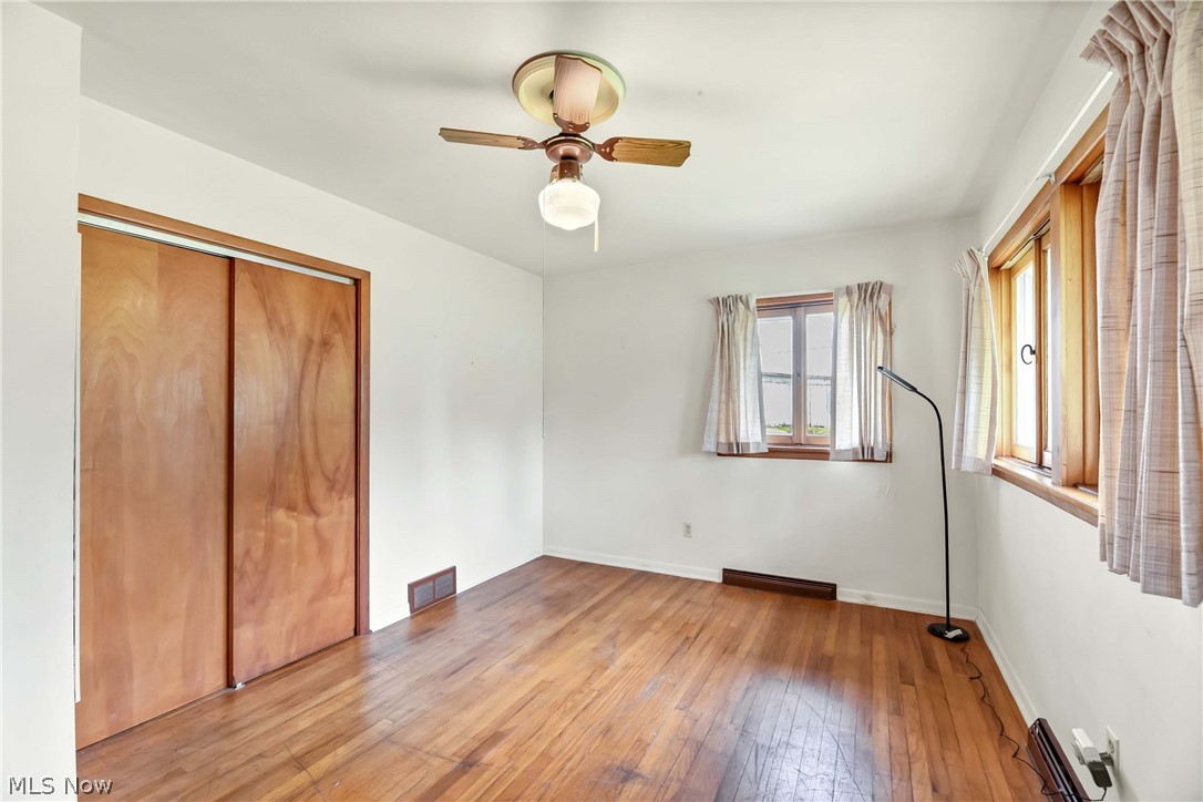 3690 Long Road Avon, OH 44011 - Photo 25 of 41 Unfurnished bedroom featuring wood-type flooring, a closet, and ceiling fan