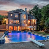 a view of a building with swimming pool and sitting area