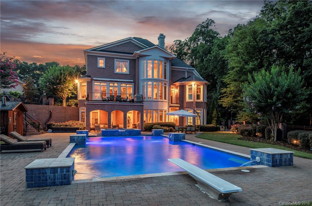a view of a building with swimming pool and sitting area