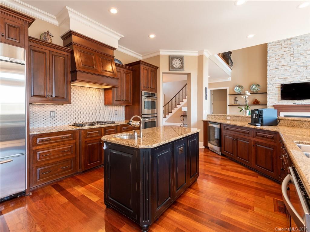 18424 Nantz Road Cornelius, NC 28031 - Photo 18 of 47 a kitchen with stainless steel appliances granite countertop a sink counter space and cabinets