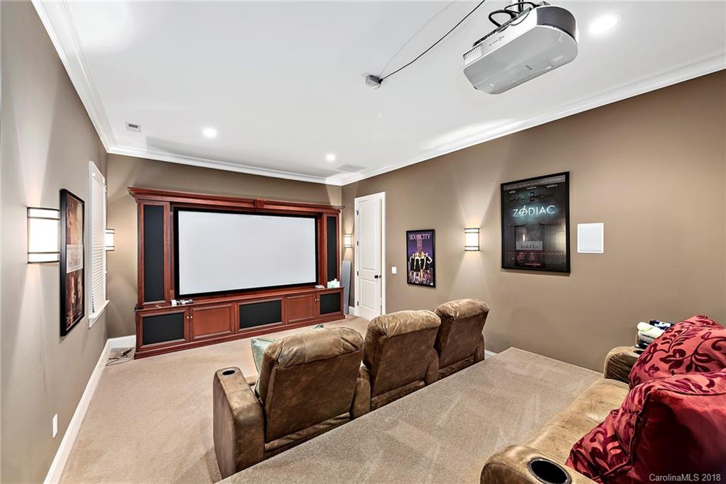 18424 Nantz Road Cornelius, NC 28031 - Photo 26 of 47 a living room with furniture projector and screen