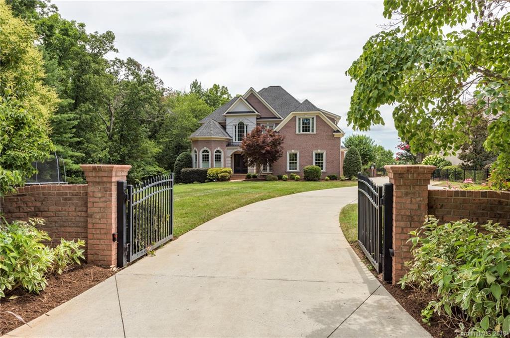 18424 Nantz Road Cornelius, NC 28031 - Photo 4 of 47 a front view of a house with a yard and trees