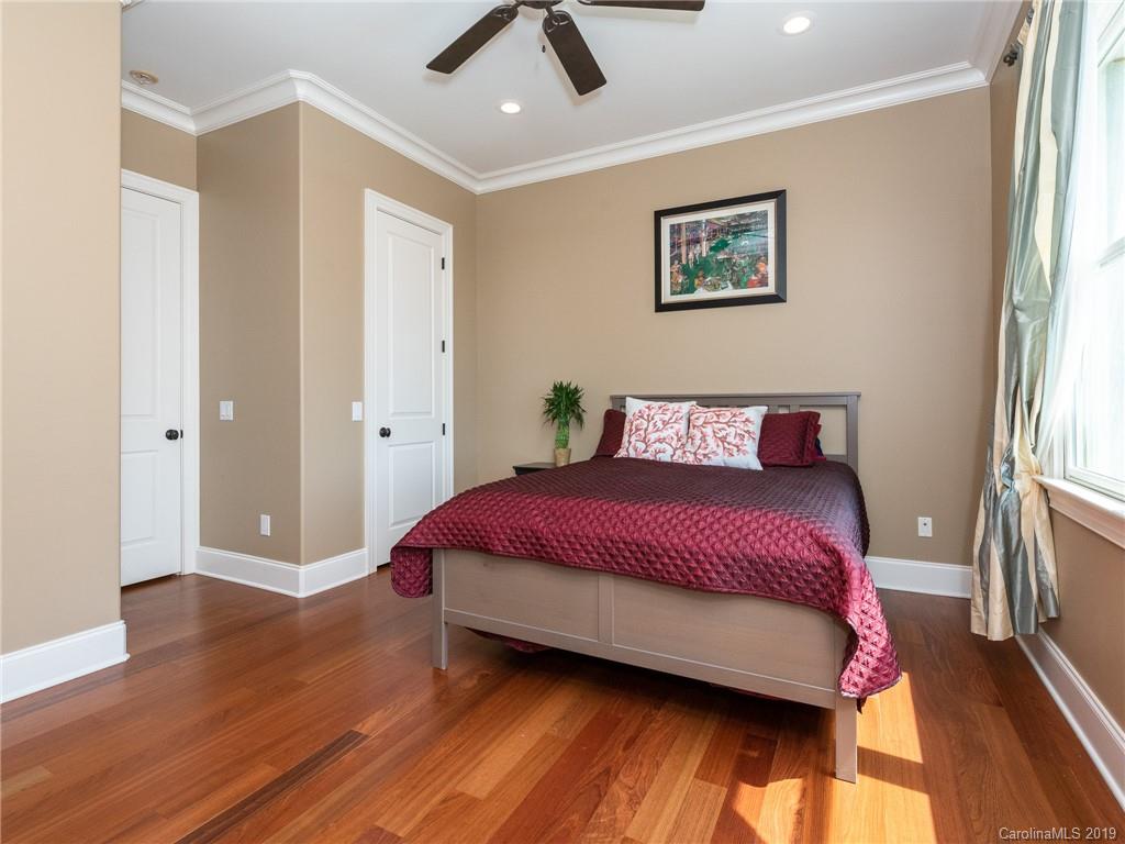 18424 Nantz Road Cornelius, NC 28031 - Photo 31 of 47 a bedroom with a bed and wooden floor