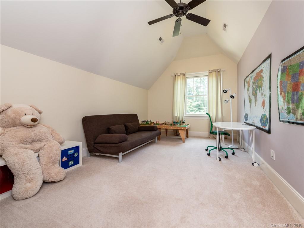 18424 Nantz Road Cornelius, NC 28031 - Photo 32 of 47 a living room with furniture and a window