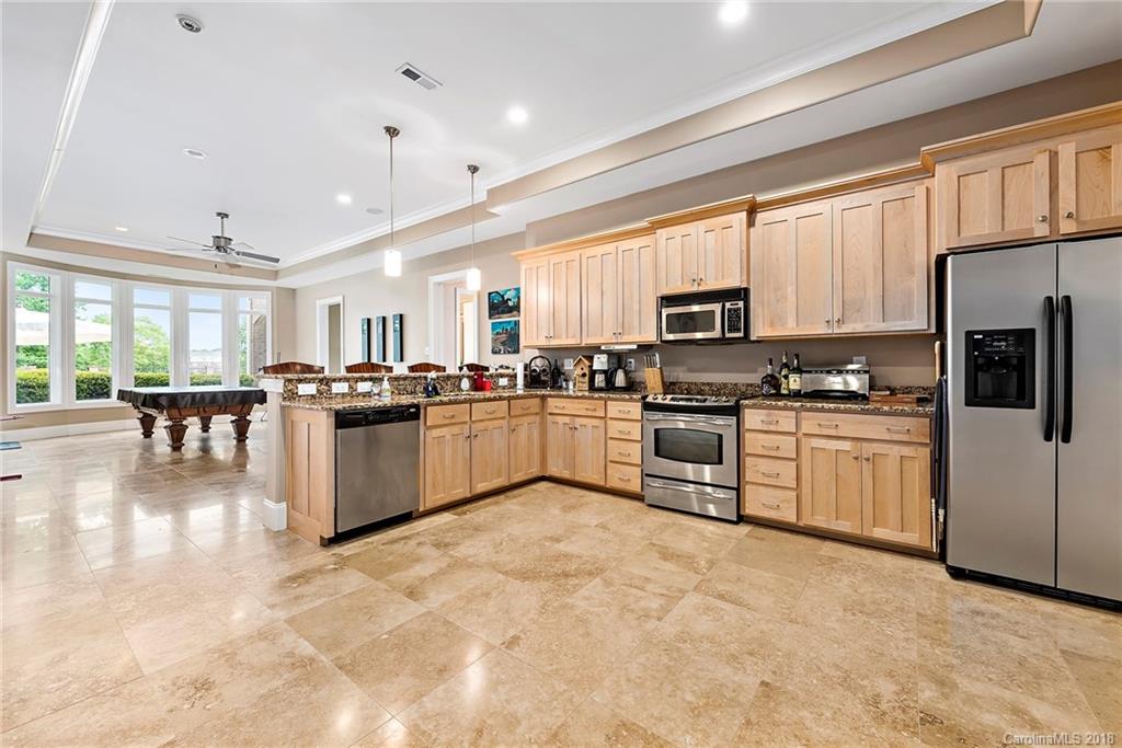 18424 Nantz Road Cornelius, NC 28031 - Photo 33 of 47 a kitchen with stainless steel appliances granite countertop a stove top oven a sink dishwasher a refrigerator and cabinets with wooden floor
