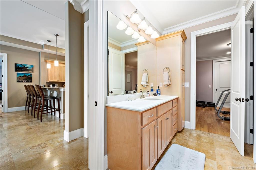 18424 Nantz Road Cornelius, NC 28031 - Photo 34 of 47 a bathroom with a sink a mirror and a shower