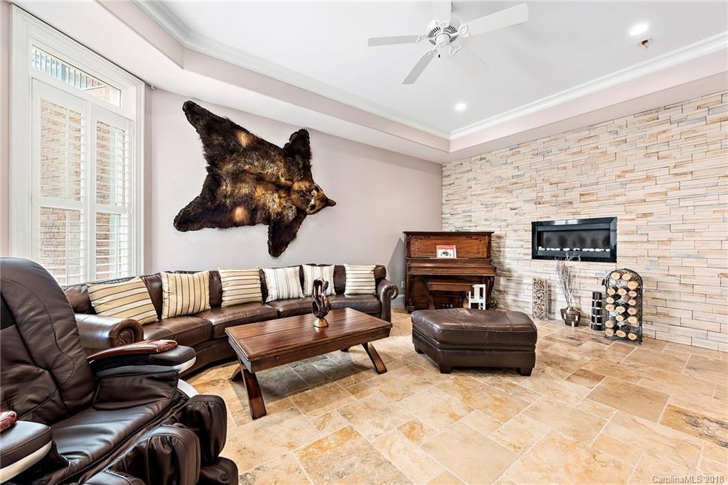 18424 Nantz Road Cornelius, NC 28031 - Photo 35 of 47 a living room with furniture and a flat screen tv